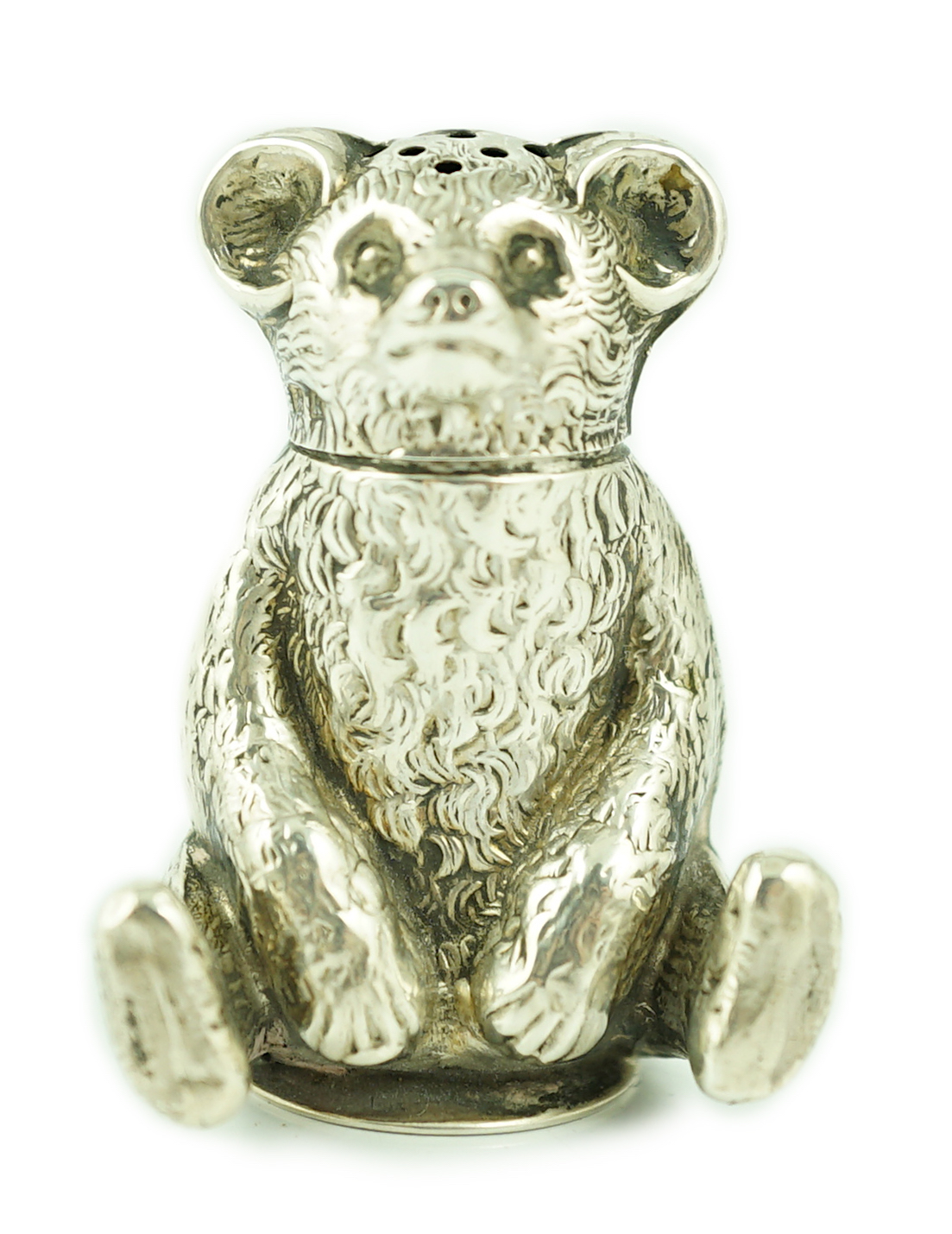 An Edwardian novelty silver pepperette modelled as a seated bear, Crisford & Norris